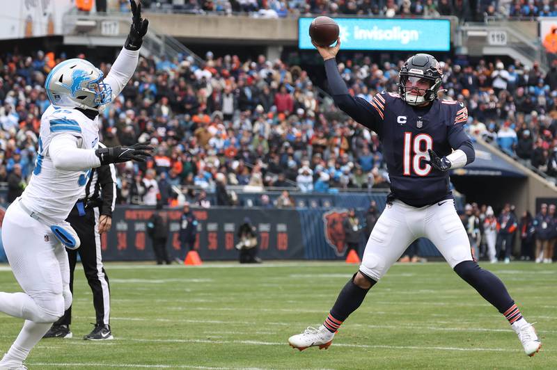 Chicago Bears quarterback Caleb Williams throws a touchdown pass to tight end Cole Kmet as he is pressured by Detroit Lions defensive end Za'Darius Smith during their game Sunday, Dec. 22, 2024, at Soldier Field in Chicago.