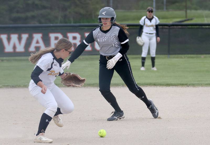 Putnam County's Gabby Doyle knocks the ball down while Flanagan-Cornell/Woodland's Kortney Harms runs toward third on Tuesday, May 2, 2023 at Woodland High School.