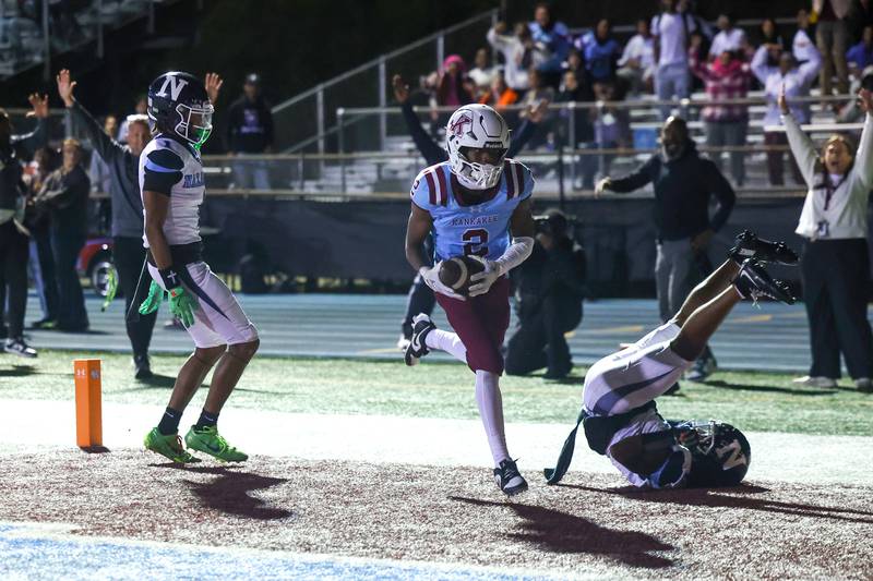 Kankakee's Ezekiel Sherrod comes down with a touchdown catch contested by Nazareth's Eddie McClain, right, during Kankakee's 33-12 loss to Nazareth on Friday, Aug. 29, 2025.