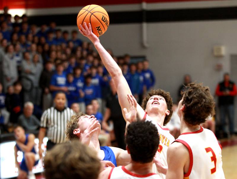 Batavia’s Darian Susic reaches for a rebound during a game against Geneva on Friday, Dec. 20, 2024 in Batavia