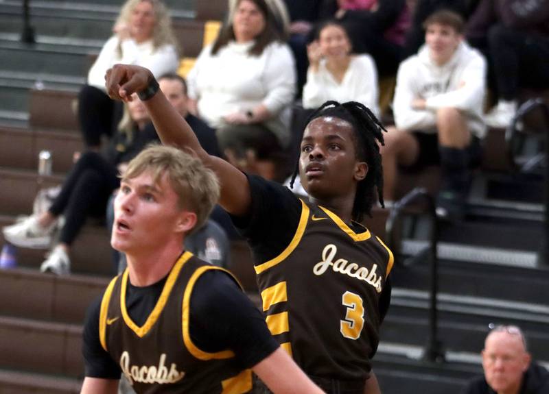 Jacobs’ Malachi Bell, back puts the finishing touch on an outside shot against Grayslake Central in varsity boys basketball Hinkle Holiday Classic action on Tuesday, Dec. 23, 2025, at Jacobs High School in Algonquin.