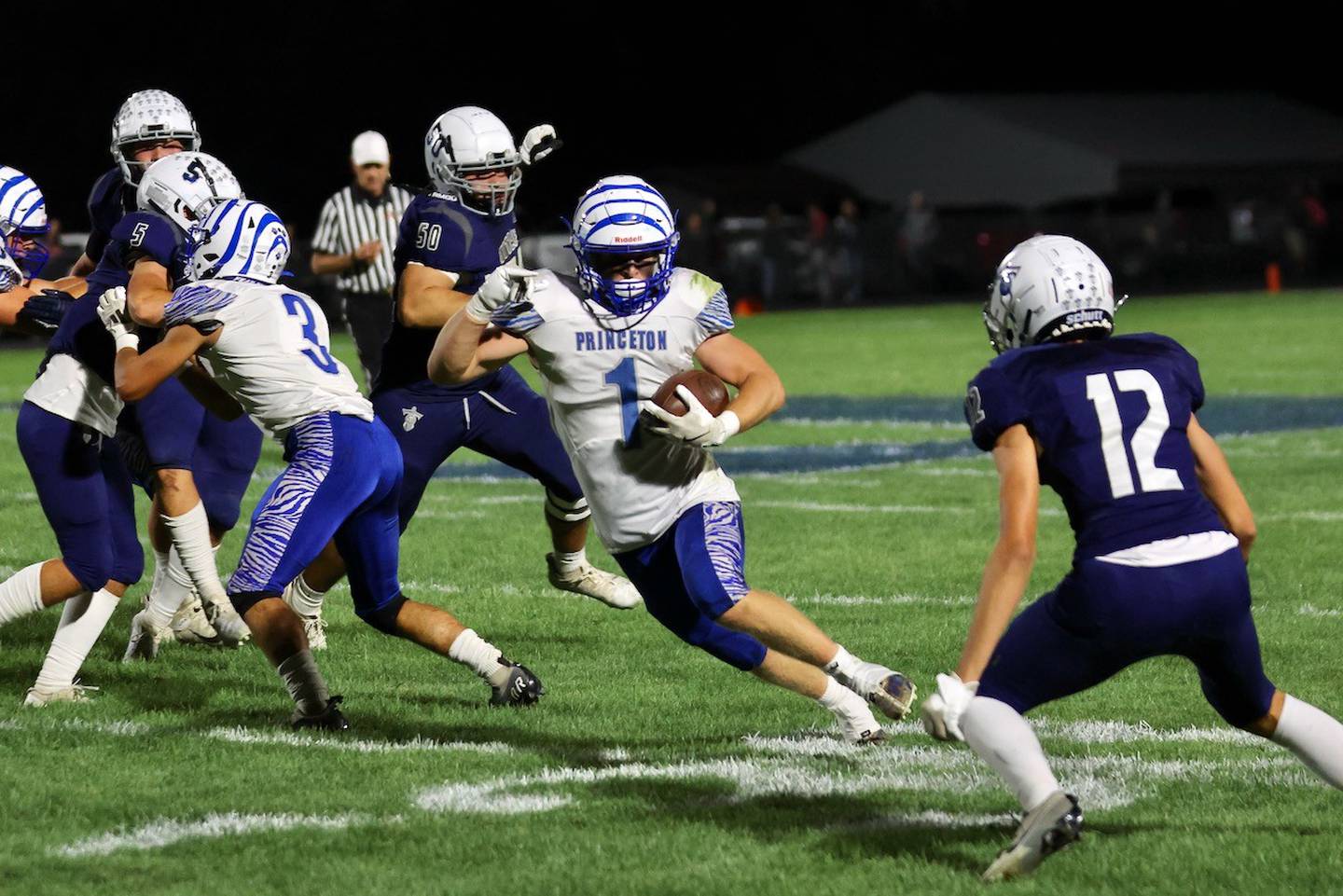Princeton's Casey Etheridge steers clear of Monmouth-Roseville's Elliot Rodgers Friday at Monmouth. The Tigers lost 31-3.
