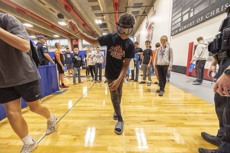 Bryon eighth grader Makaii Manley attempts to walk a straight line with drunk goggles on while visiting a Dixon police booth Friday, Oct. 17, 2025. Sixty-two local businesses and organizations set up at SVCC to introduce regional eighth graders to career options.