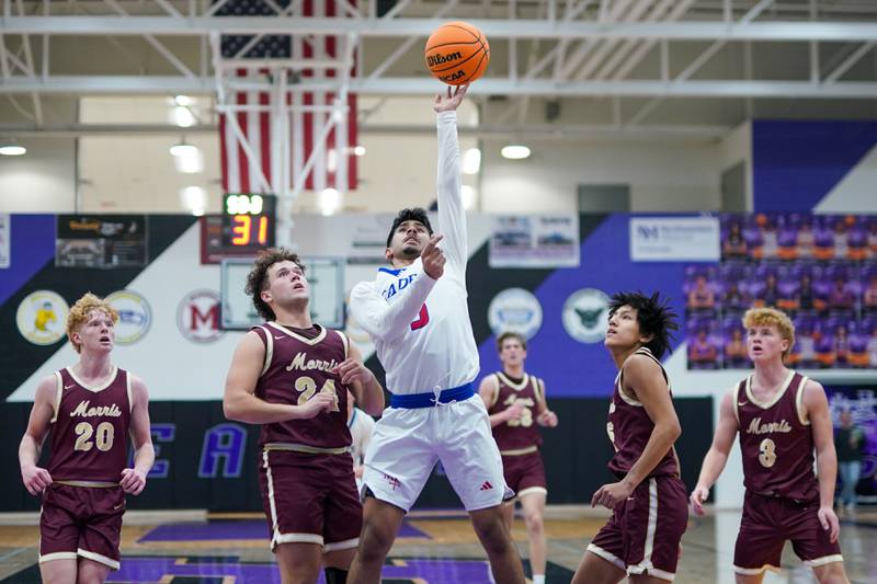 Marmion's Ali Muhammed Tharwani (5) shoots the ball in the post against Morris’ Colin Pfeifer (24) during a basketball game in the opening round of the 61st annual Plano Christmas Classic at Plano High School on Monday, December 23, 2024.
