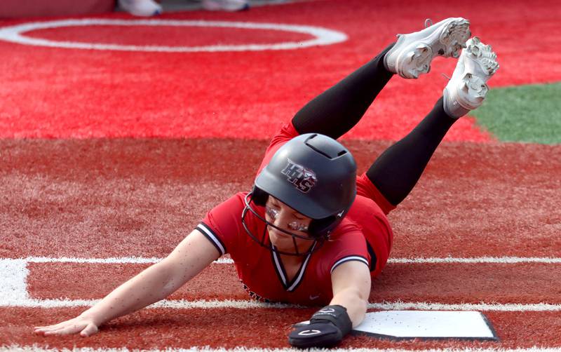 Huntley’s Megan Bzdusek skids safely across home plate against DeKalb in IHSA Class 4A Sectional Semifinal softball action at Barrington High School in Barrington on Wednesday, June 4, 2025.