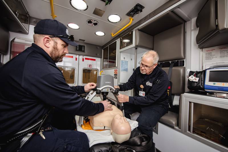 CGH Paramedic Kevin Allen (left) and CGH EMT Tom Hartman practice deploying a chest compression system.