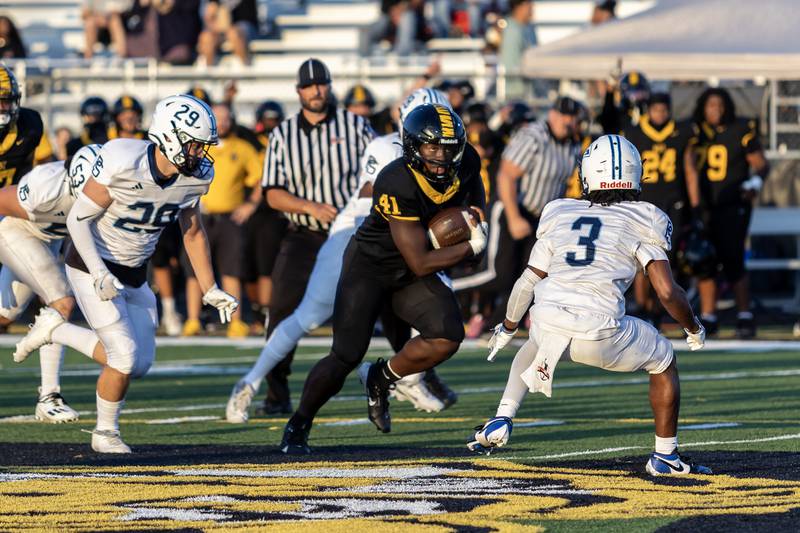 Joliet West's Gregory Lee picks-up yards during a varsity football home game against Plainfield South on Sept. 12, 2025.