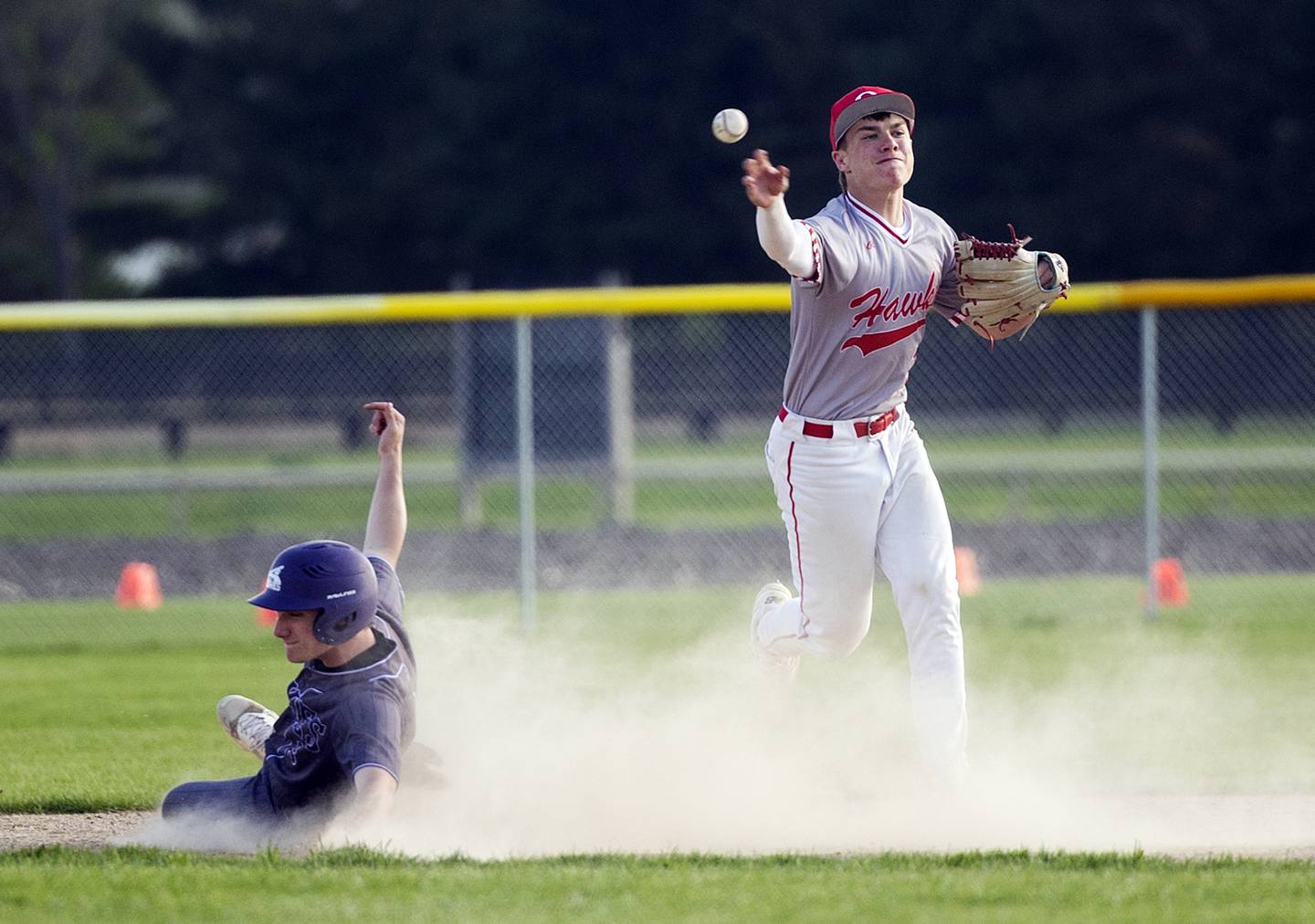 Dixon’s Jack Redell slides to break up a double play by Oregon’s Jackson Messenger Thursday, April 23, 2026.