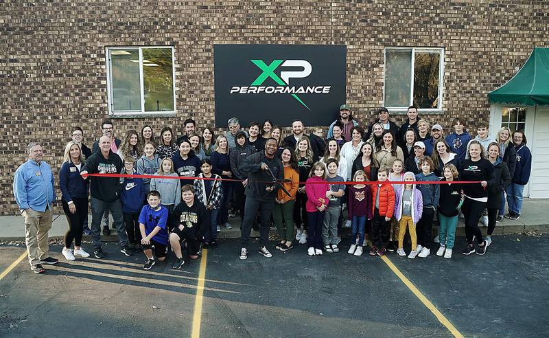 XP Performance & Coaching owner Robert Cook and his wife, Brittany, along with their friends, family, clients, and the staff and board members of the Cary-Grove Area Chamber of Commerce, celebrate the business's grand opening of with a ribbon-cutting ceremony on Friday, Nov. 5, 2021.