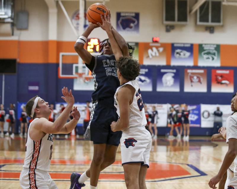 Oswego East's Mason Lockett (23) hangs in the air on a short jump shot during their basketball game between Oswego East at Oswego Friday, Jan 9, 2026 in Oswego.