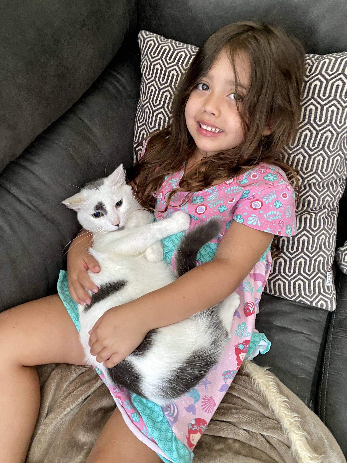 Rachel and Ryan Evans' daughter Claire, 6, poses with Leo, 10. All four of the family's pets died as a result of a fire at the family's Minooka home on Labor Day.