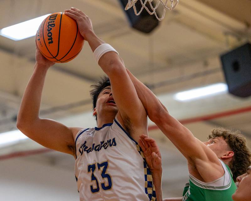 Marquette's Blayden Cassel (33) is fouled by Joey Starks (11) of Dwight as he lays up ball on Saturday, Feb. 21, 2026 at Marseilles Elementary School.
