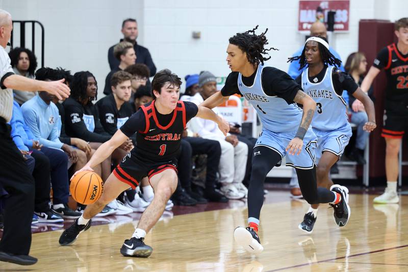Lincoln-Way Central's Nolan Morrill runs a play under pressure from Kankakee's Lincoln Williams during the Kays' 54-50 victory over Lincoln-Way Central in the 75th Kankakee Holiday Tournament maroon bracket championship on Sunday, Dec. 28, 2025.