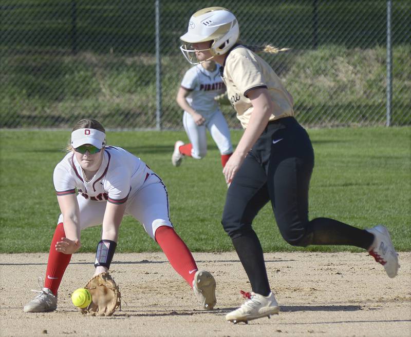 Ottawa’s Piper Lewis fields a ground ball at shortstop as Sycamore’s Riley Schuller looks to advance to third Wednesday at Ottawa.
