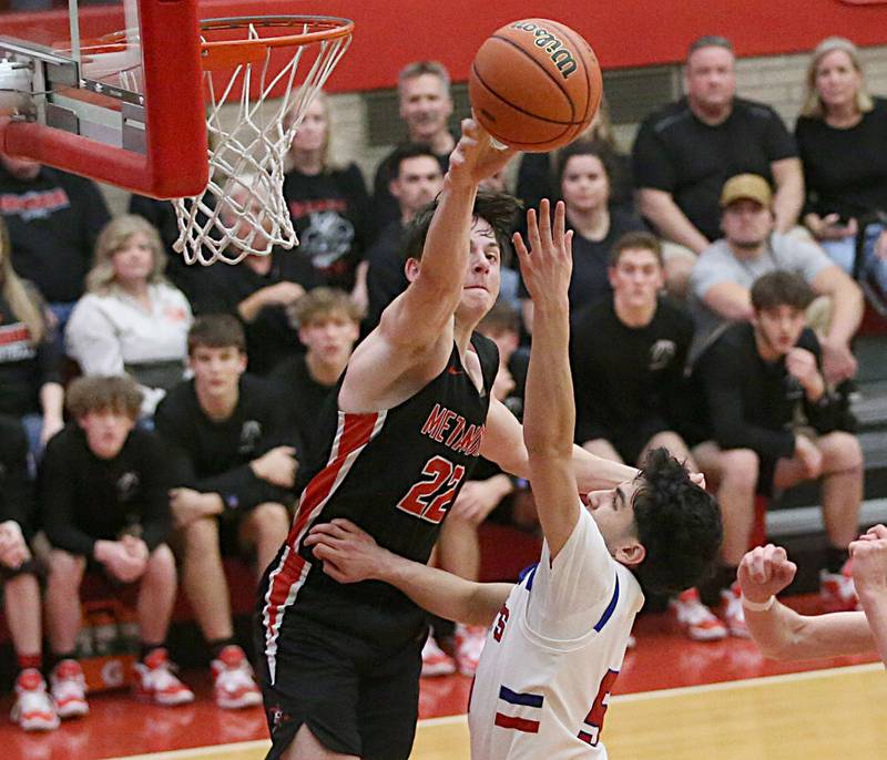 Metamora's Tyson Swanson blocks Marmion's Jacob Piceno's shot during the Class 3A Super-Sectional on Monday, March 6, 2023 at Ottawa High School.
