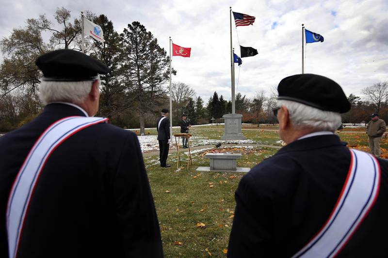 Members of the Knights of Columbus participate in the Veterans Day flag placement ceremony Tuesday, Nov. 11, 2025, at the gravesites of veterans at McHenry County Memorial Park Cemetery in Woodstock. Members of the Knights of Columbus Patriotic 4th Degree from the Bishop Boylan Assembly placed American Flags at nearly 140 veterans' grave markers.