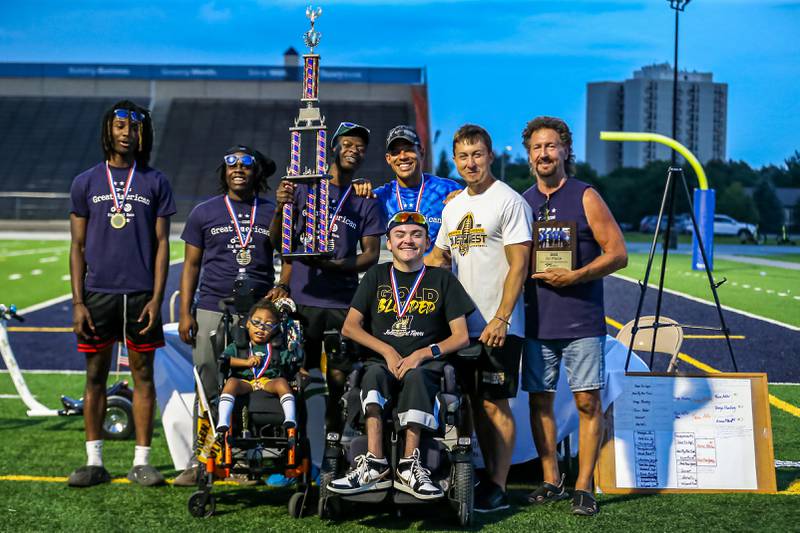 Team Adler racing for Joliet West pose with their 1st place plaque and trophy after the Great American Big Wheel Race.  July 22nd, 2023