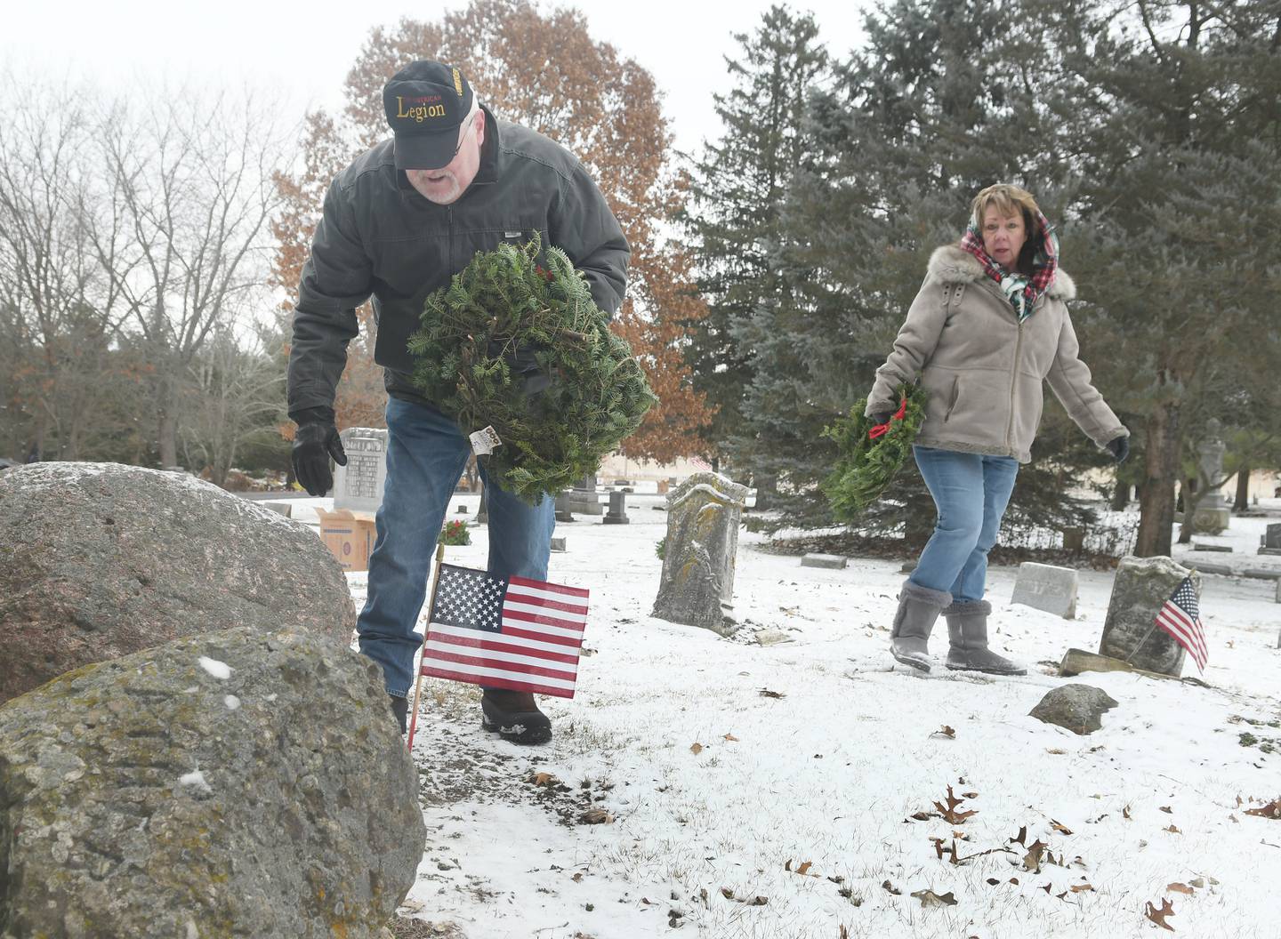 Bill and Stephanie Nelson of Oregon lay wreaths on veterans' graves at Daysville Cemetery on Dec. 17 during the Wreaths Across America project. Bill was laying a wreath on  the grave of Virgil Reed who fought in the Civil War.