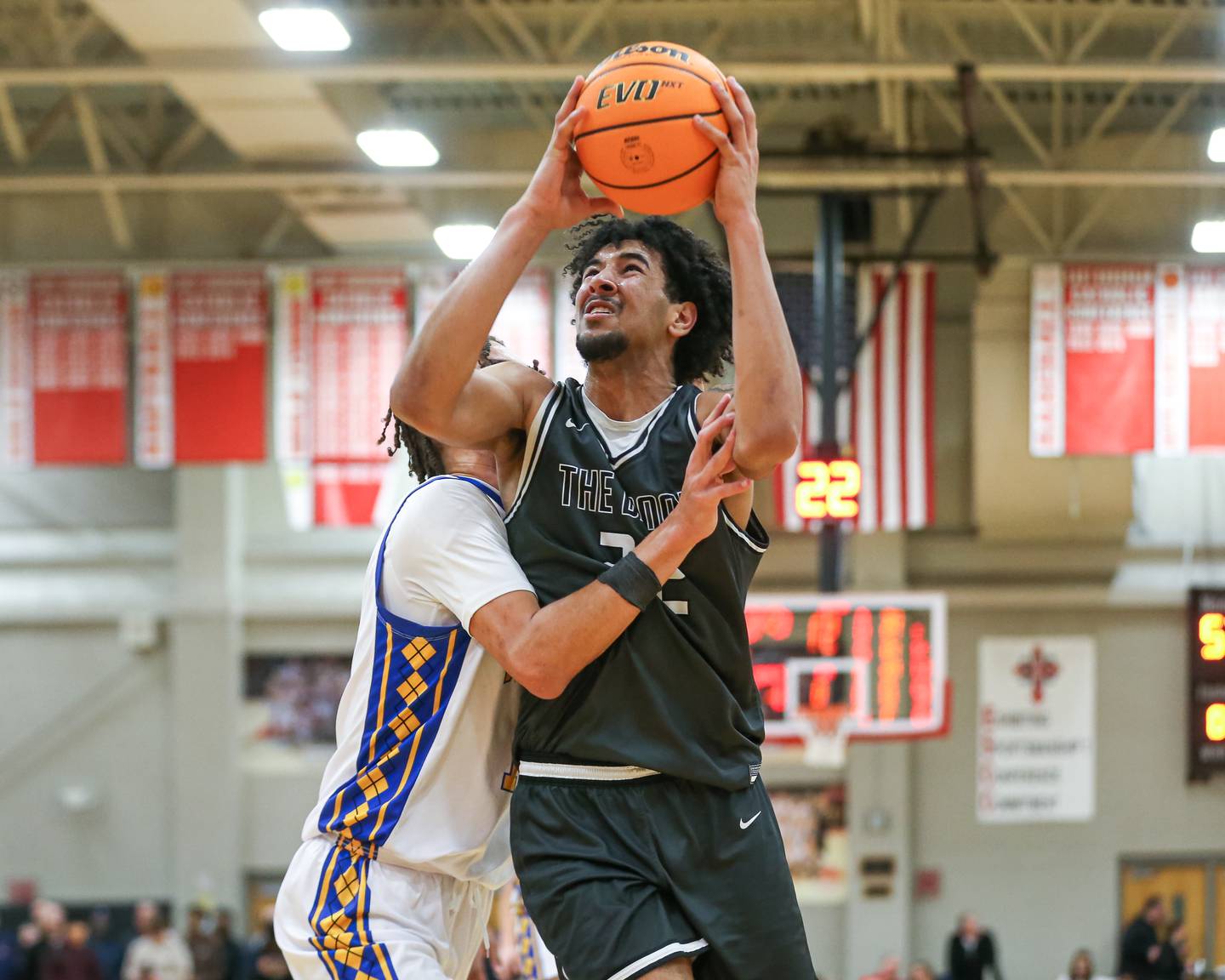 Bolingbrook's JT Pettigrew (22) is fouled on a move under the basket during their When Sides Collide Shootout basketball matchup between Warren and Bolingbrook. Jan 25, 2025 in Lisle.