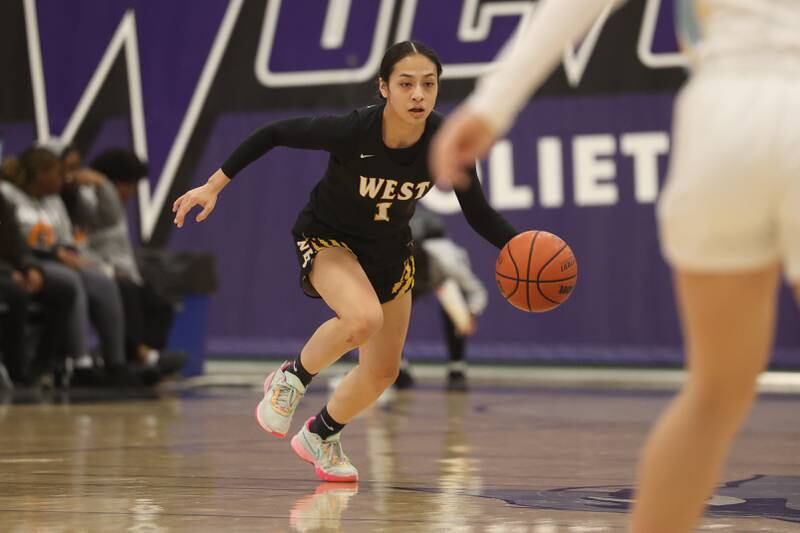 Joliet West’s Christina Keoborakot works the ball upcourt against Joliet Catholic in the 2023 WJOL Girls Basketball Tournament on Friday, Nov. 17, 2023, in Joliet