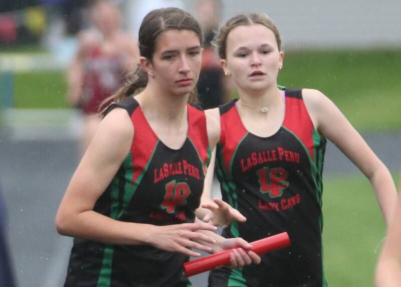 L-P's Ashley Lord takes the baton from Kiley Domyancich in the 4x800 meter relay during the Class 2A girls track and field Sectional on Thursday, May 9, 2024 in Princeton.