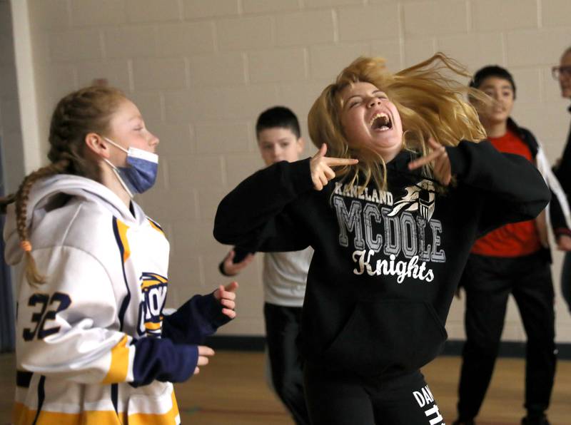 Kaneland McDole Elementary School fifth-graders Haley Conro (left) and Emily Craft participate in a dance party at the school on Friday, March 25, 2022. McDole students raised over $33,000 to benefit Feed My Starving Children, A.D.O.P.T. Pet Shelter and the school’s physical education department and were treated with a dance party.