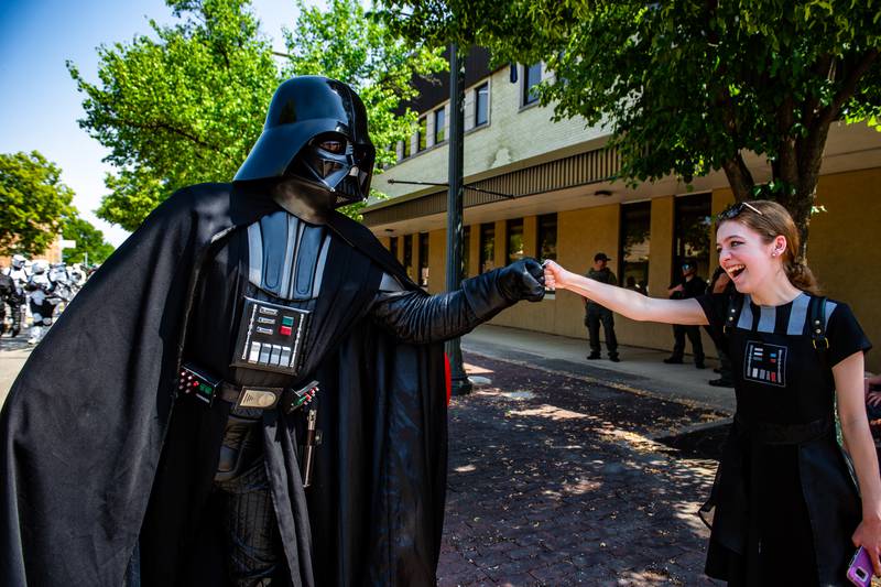 Darth Vader fist bumps a fan during the Star Wars Day parade on Saturday, June 3, 2023 in Joliet.