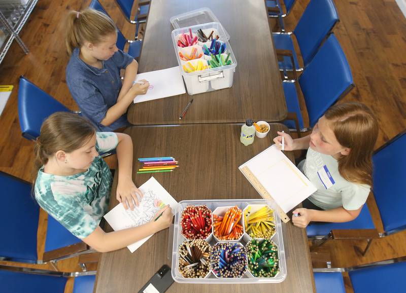 Morgan Shadle, Kaitlin Gill and Savannah Kleinfelter, create images in the arts and crafts room during the Princeton Chamber of Commerce Business After Hours on Thursday, June 19, 2025 at the Second Story Teen Center in Princeton.