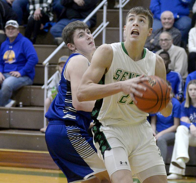 Seneca’s Lane Provance (21) turns to the basket past Newark’s Cole Reibel during the title game of the Seneca Thanksgiving Turkey Tournament on Saturday.