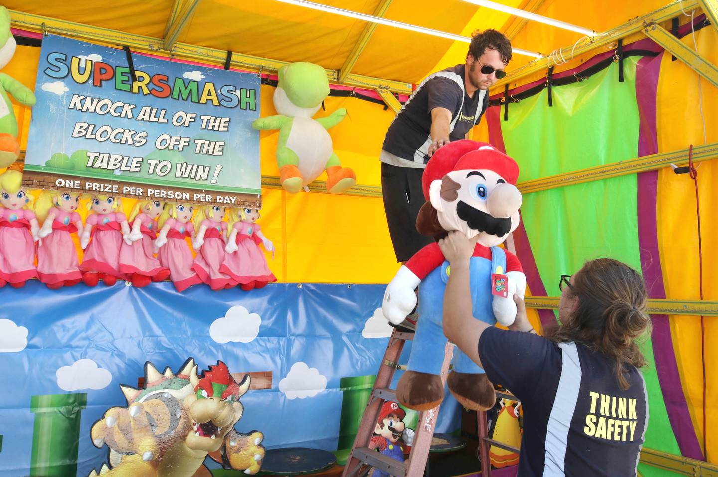 Workers from North American Midway Entertainment set up one of the games in the carnival Thursday, Aug. 24, 2023, in preparation for this weekend’s DeKalb Corn Fest. The festivities begin Friday at 3 p.m. in Downtown DeKalb.