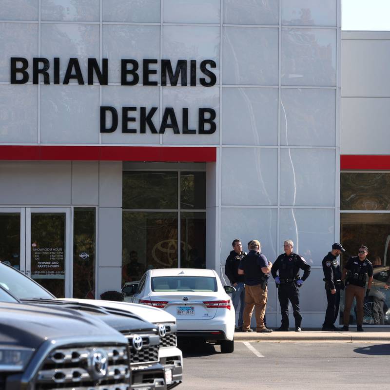 Law enforcement officers gather Wednesday, Oct. 23, 2024, outside of the Brian Bemis Toyota car dealership in DeKalb after responding to a stabbing where multiple employees were injured. The incident ended after police shot the man wielding the knife authorities said.