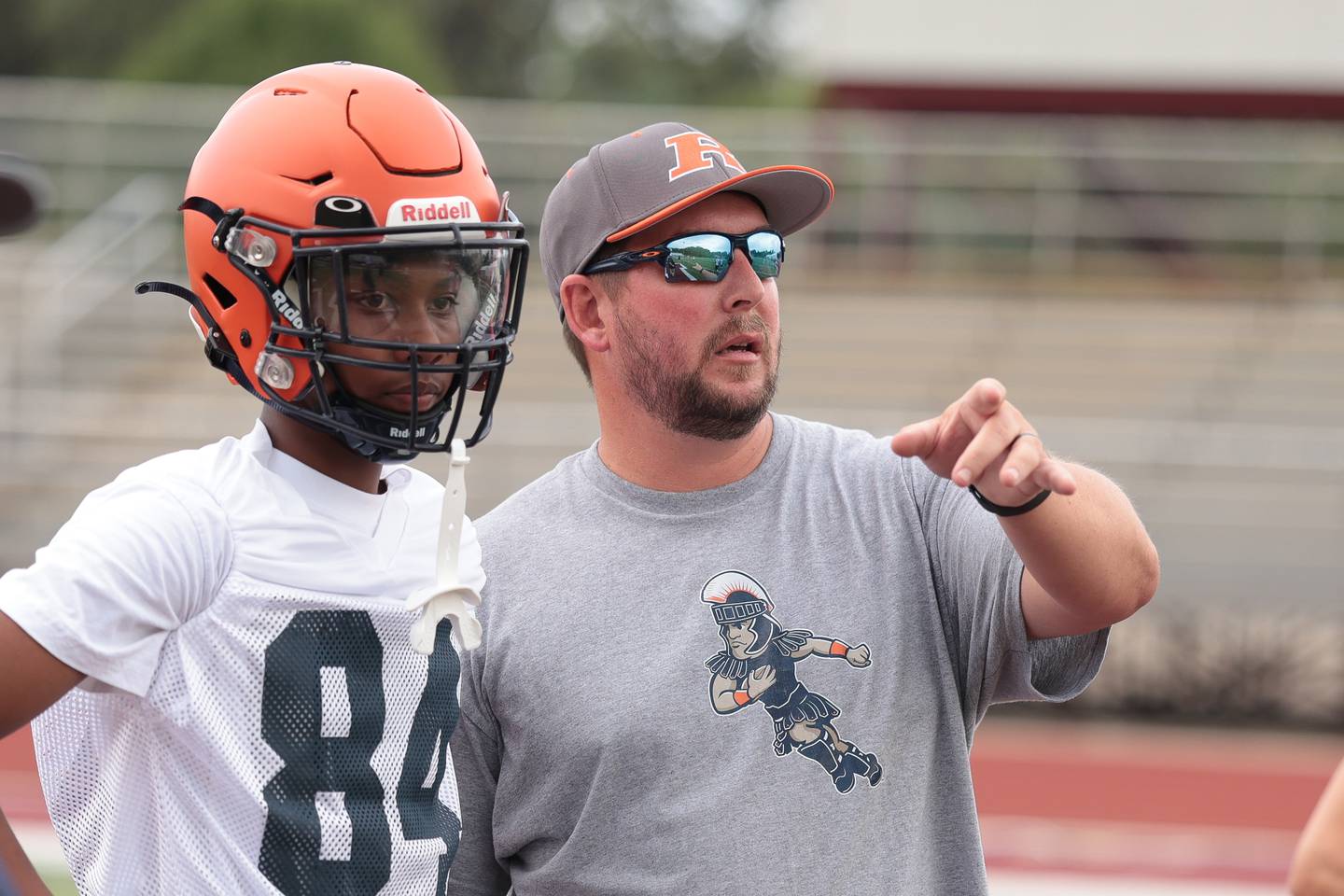 Romeoville's Vincent Flowers listens to head coach Justin Trovato between snaps against Plainfield Central at Morris' 7-on-7 scrimmage on Tuesday, July 8, 2025 in Morris.