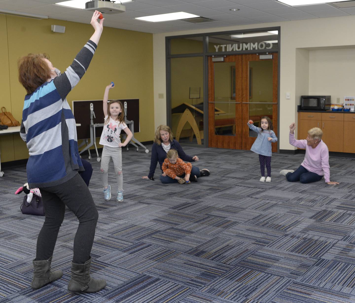 It wasn’t all reading during a children's story hour Tuesday, April 5, 2022, at the Reddick Library in Ottawa as Youth Services Librarian Annette Kohn leads children in a special shaker song and dance.