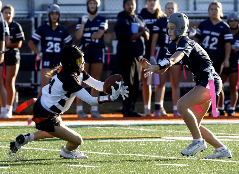 McHenry's Morgan Frederick intercepts a pass intend for Cary-Grove's Sofia Seaburg during the IHSA McHenry Regional girls flag football championship game on Wednesday, Oct. 8, 2025, at McCracken Field in McHenry.