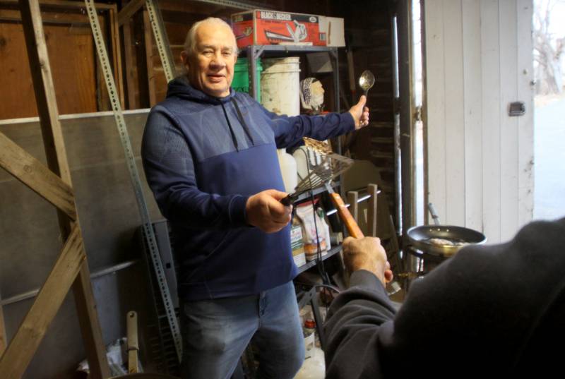 “On guard!” Says Jerry Trachsler of Crystal Lake as he jokes with others on latke frying detail during a Chanukah party at The McHenry County Jewish Congregation Sunday.