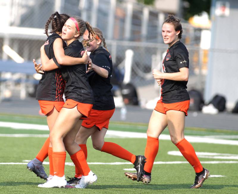 St. Charles East players celebrate teammate Tatum Smith’s (center) goal during a Class 3A West Chicago Sectional semifinal win over Batavia on Tuesday, May 23, 2023.