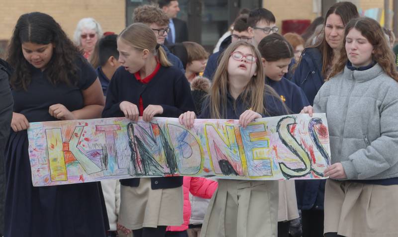 Students from Academy of St. Carlo Acutis hold a banner that reads "Kindness" as they walk during a Eucharistic Procession to St. Joseph’s Catholic Church on Friday, Jan. 30, 2026 in Peru. ver 350 students and staff from Academy of St. Carlo Acutis celebrated the very first all-school Mass.