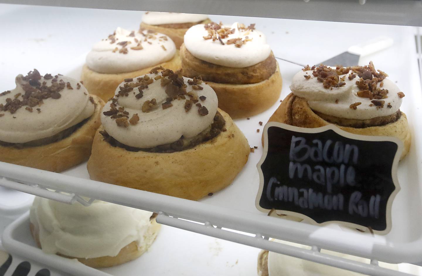 Bacon maple cinnamon rolls for sale on Friday, June 27, 2025, at the recently opened Black Market Bakery in downtown Crystal Lake.