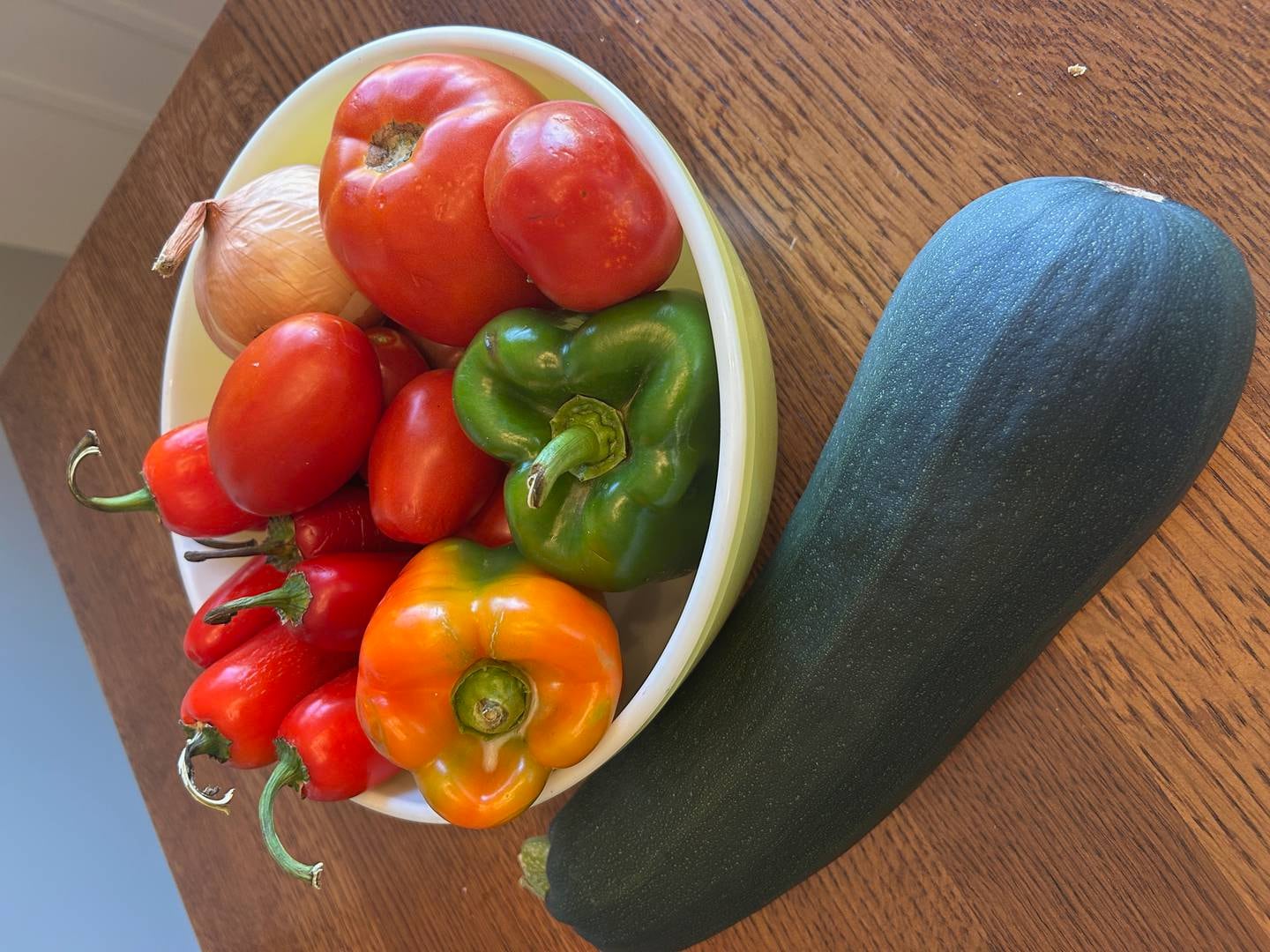 Peppers, tomatoes, onions and zucchini highlight the late garden bounty.