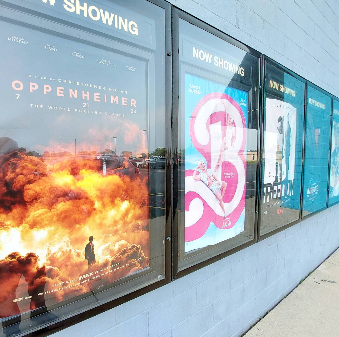 Posters advertise "Oppenheimer" and "Barbie" on the facade of Streator Eagle 6 theater on Monday, July 24, 2023.