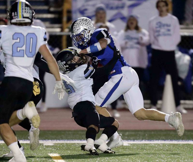 St. Charles North's Drew Surges (6) bowls over Maine West’s Adam Aboebied (5) Friday October 28, 2022 in St. Charles.