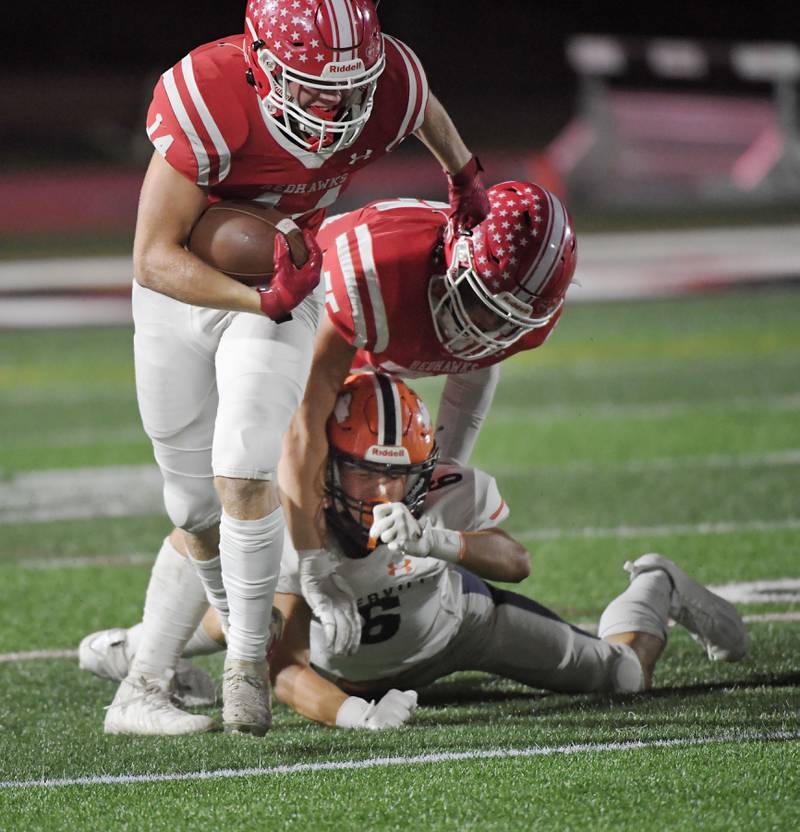 Naperville North’s Grifin Fiore loses his grip on Naperville Central’s Logan Devick as Daniel Conway blocks him out of the play in a high school football game at North Central College in Naperville on Friday, September 29, 2023.