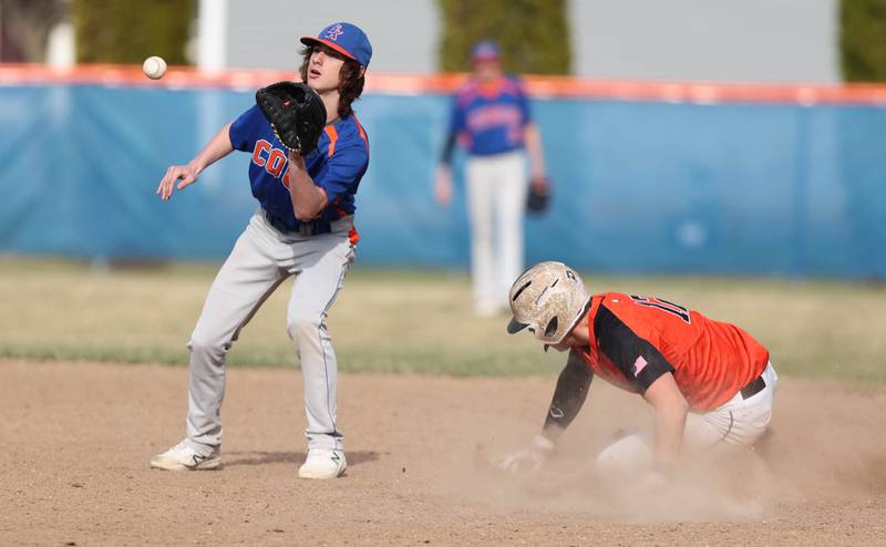 Genoa-Kingston's Aidan Awe takes the throw as Winnebago's Logan Watson slides in safely with a stolen base during their game Tuesday, April 12, 2022, at Genoa-Kingston High School.