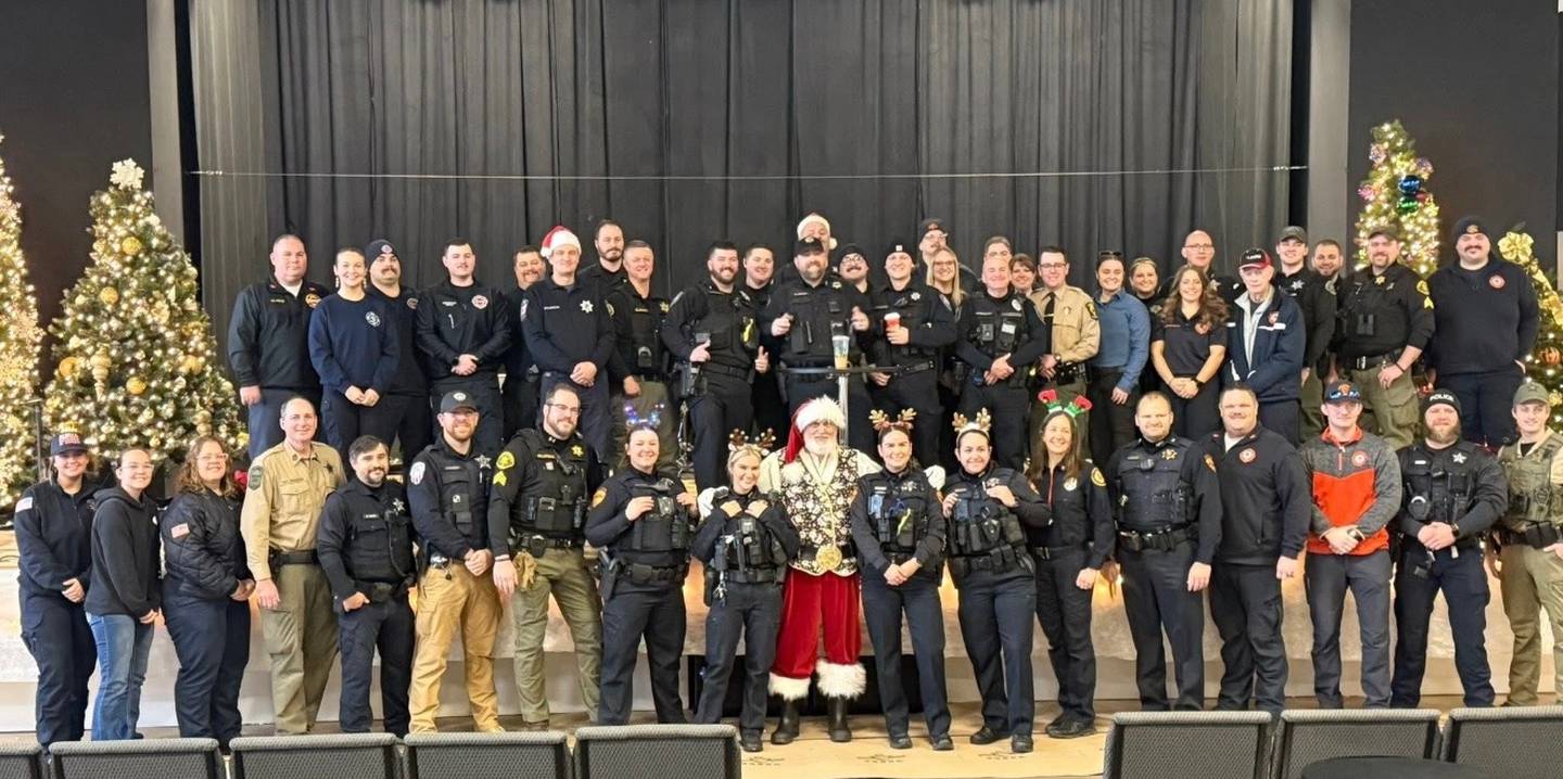 Police, firefighters, military and other first responders from around Grundy County with Santa Claus during the 2025 An Evening with Santa Claus event.