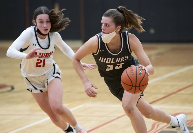 Prairie Ridge's Karsen Karlblom (right) dribbles the ball past Huntley's Samantha Campanelli (left) during the Huntley vs. Prairie Ridge girls basketball game on Tuesday, November 30, 2021 at Huntley High School. Ryan Rayburn for Shaw Local