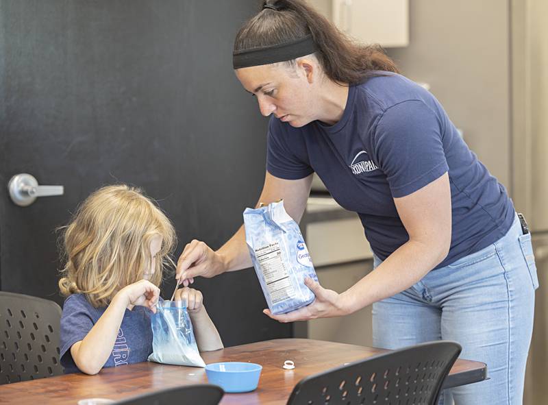 Michele Kreczmer adds sugar to a young campers budding homemade ice cream Wednesday, May 31, 2023. Kreczmer has recently be named Dixon Park District recreation supervisor and will focus on youth sports and camps. The Kids Table is Kreczmer’s new program where kids combine science experimentation and recreational fun.
