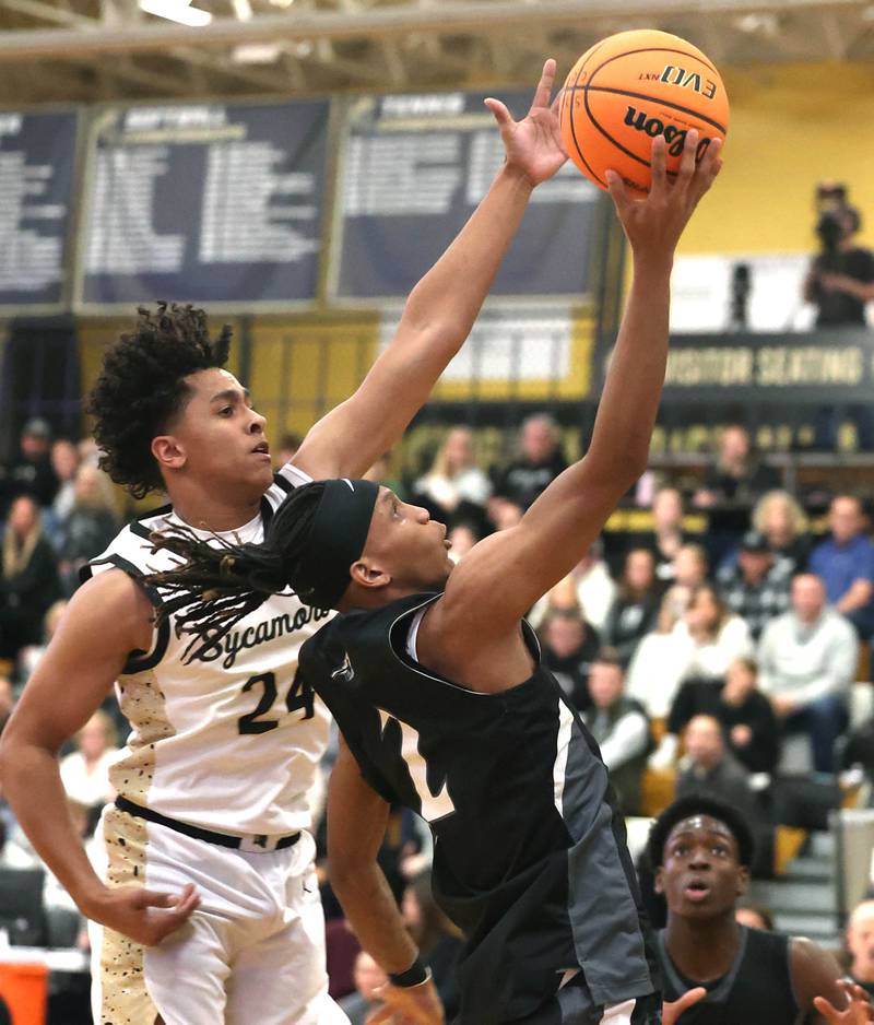 Kaneland's Isaiah Gipson gets to the basket in front of Sycamore's Tyler Townsend during their game Friday, Jan. 9, 2025, at Sycamore High School.