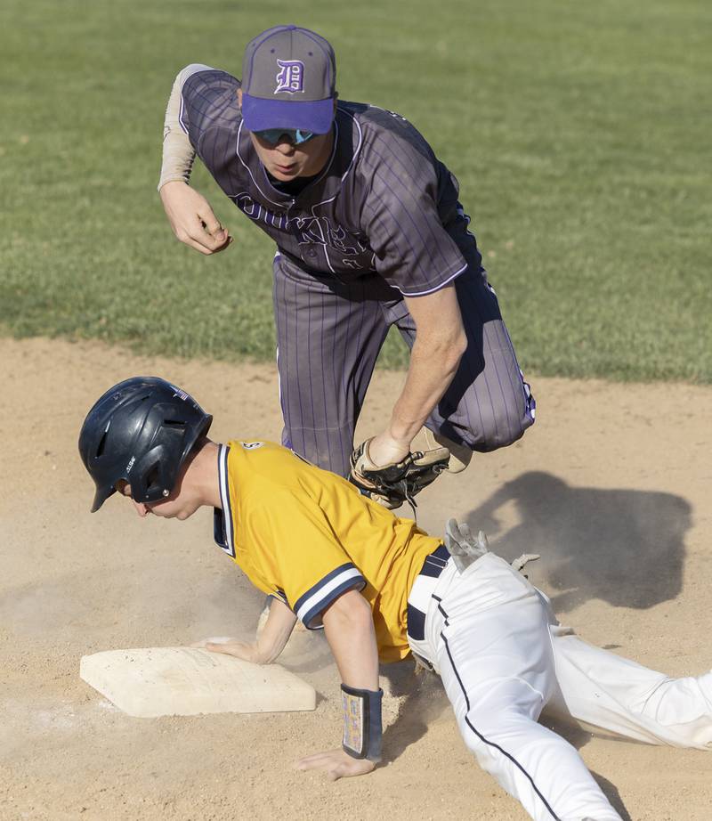 Sterling’s Cale Nettleton dives back safely to third against Dixon’s Jagger Kemp Friday, May 23, 2025.