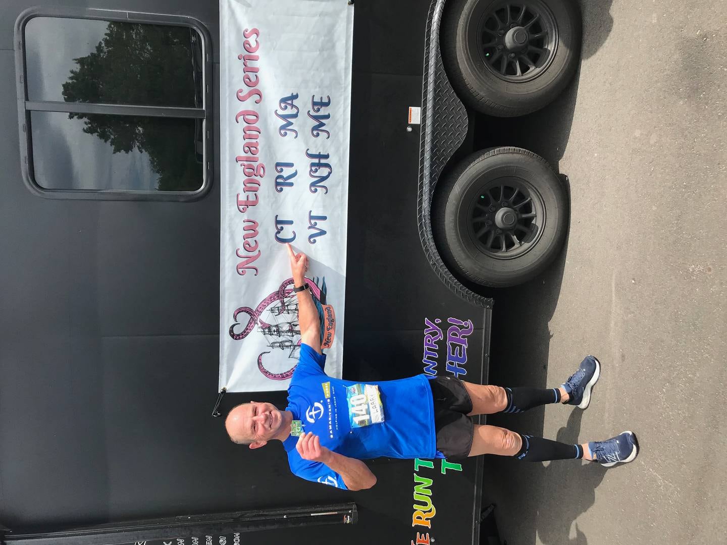 Larry Burton, 65, of Martinton, points to a 
state on a banner after running a marathon there on his journey to run a marathon in all 50 states. He completed the quest on Aug. 6 by running a marathon in Juneau, Alaska.