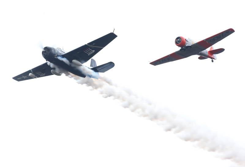 A TBM Avenger and a T-6 Texan fly over during the 44th annual Pearl Harbor parade and memorial ceremony on Saturday, Dec. 2, 2023 in Peru.